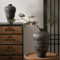 Close up of textured black vase finish with bronze undertones