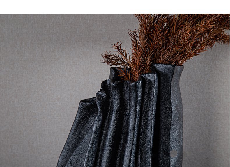 Close up of pleated organic texture on black vase