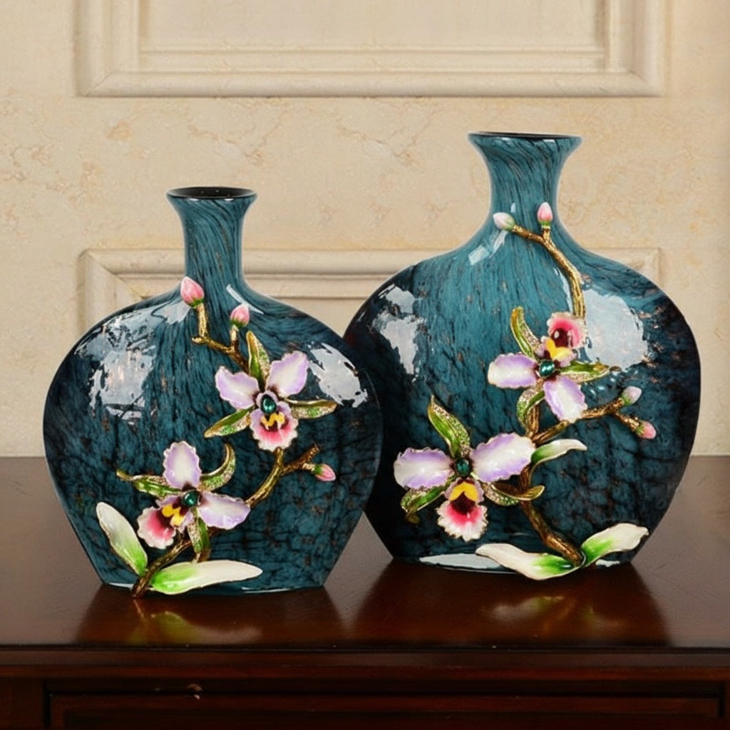 Two blue textured vases with enamel flowers side by side