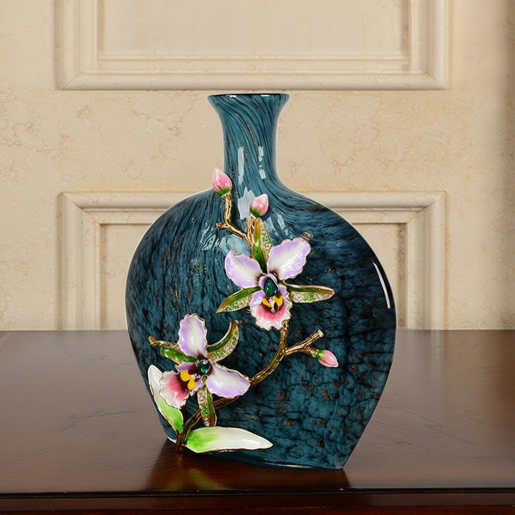 Angled view of blue glass vase with pink enamel orchid detail