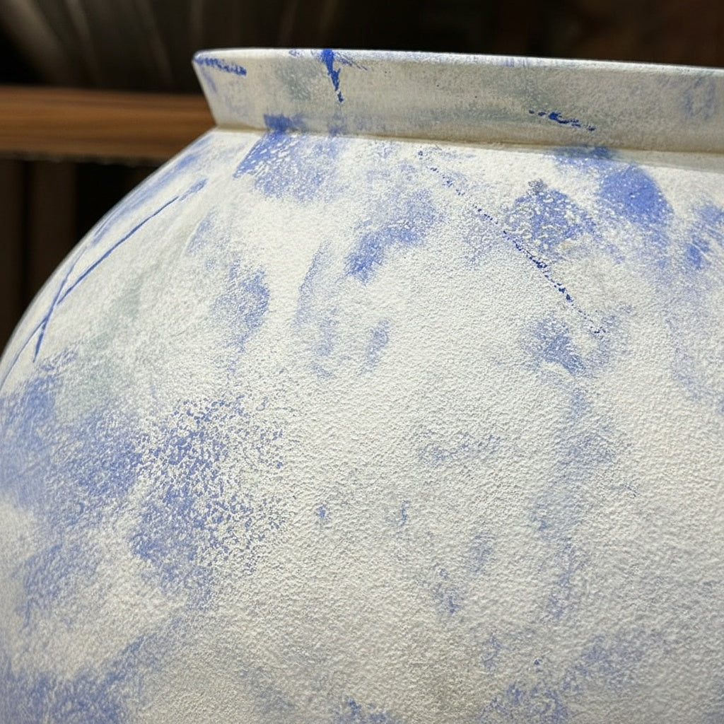 Close up detail of blue and white mottled texture on ceramic vase rim