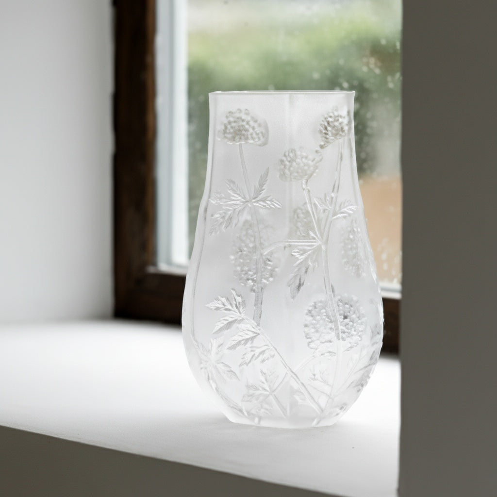 Textured botanical clear glass vase on a windowsill