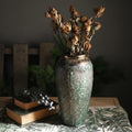 Lifestyle shot of rustic vase on table with books