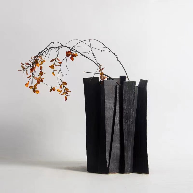 Black architectural vase with dried botanicals