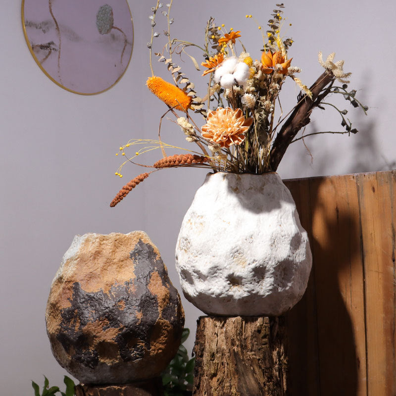 Textured ceramic boulder vases styled with dried flowers