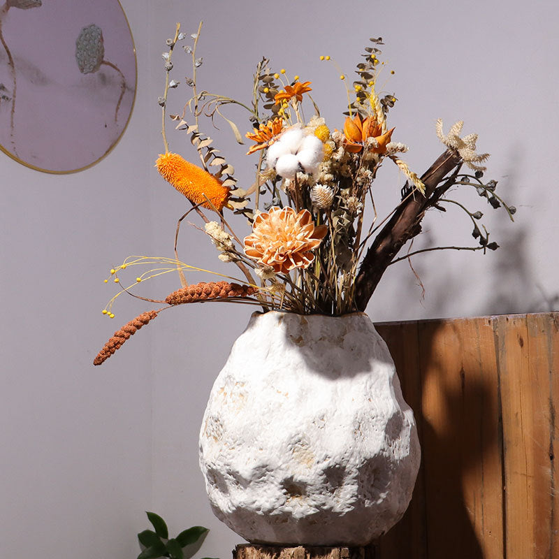 White textured ceramic vase with dried floral arrangement