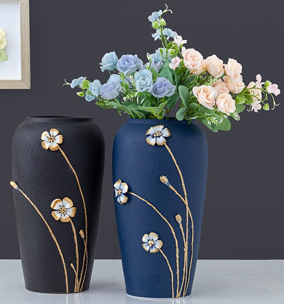 Two textured ceramic vases with floral arrangements