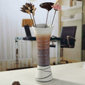 Textured ceramic vase styled on desk with dried flowers