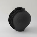 Matte black ceramic vase with organic layered ridge detail