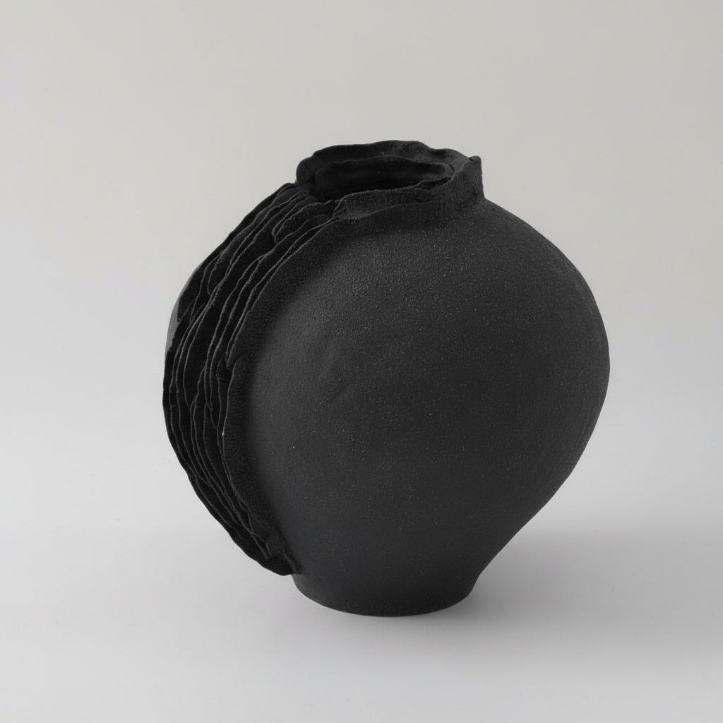 Matte black ceramic vase with organic layered ridge detail