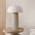 Front view of textured ceramic mushroom table lamp on wooden side table