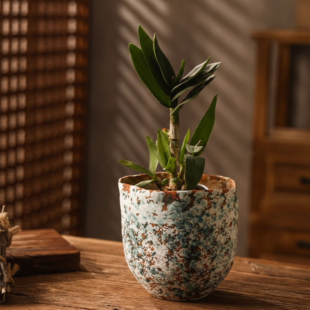 Side view of artisanal ceramic pot with organic rim on wooden table