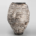 Front view of textured ceramic vase with distressed white finish