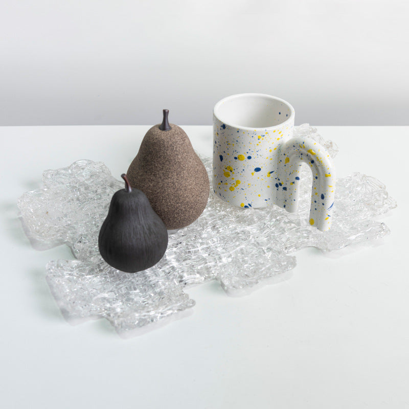 Lifestyle setting with ceramic pears and mug on glass tray