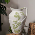 Close up of white ceramic pitcher vase with handle
