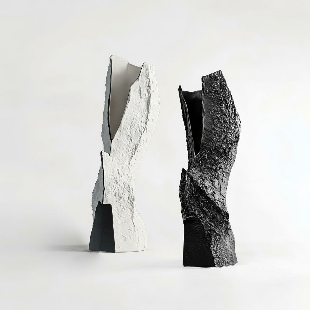 Two textured ceramic rock vases in black and white standing together