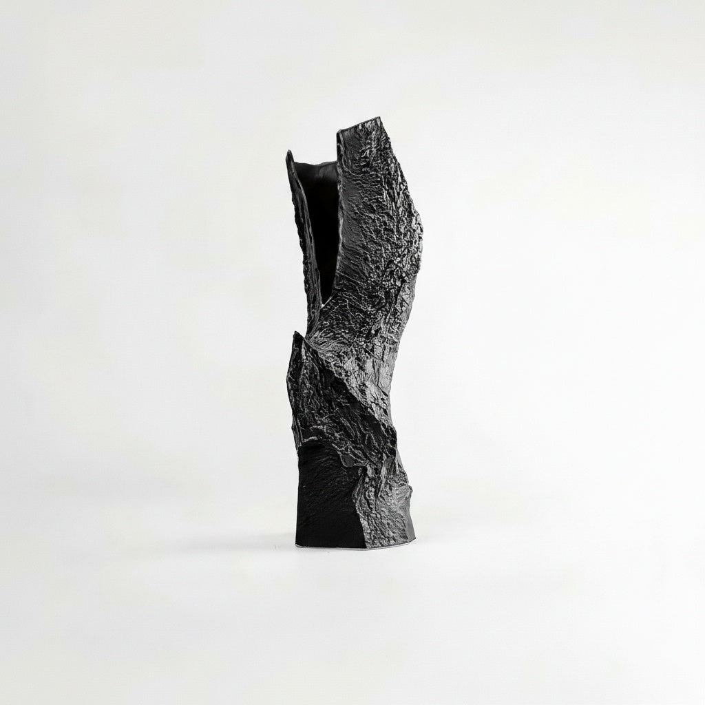 Black textured ceramic sculptural vase with jagged rock design