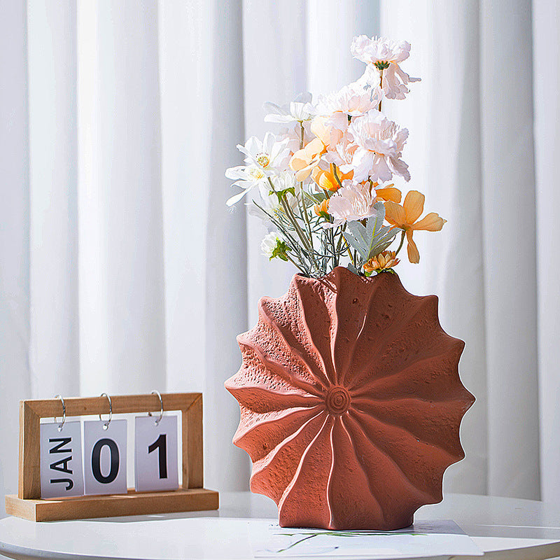 Terracotta ceramic vase on table with calendar