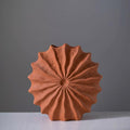 Detailed front view of sunburst ceramic vase