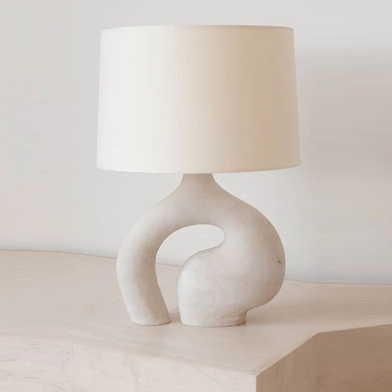 Front view of abstract resin table lamp with fabric shade