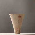 Side view of rustic cream and rust ceramic vase