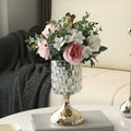 Textured glass and gold pedestal vase with pink floral arrangement
