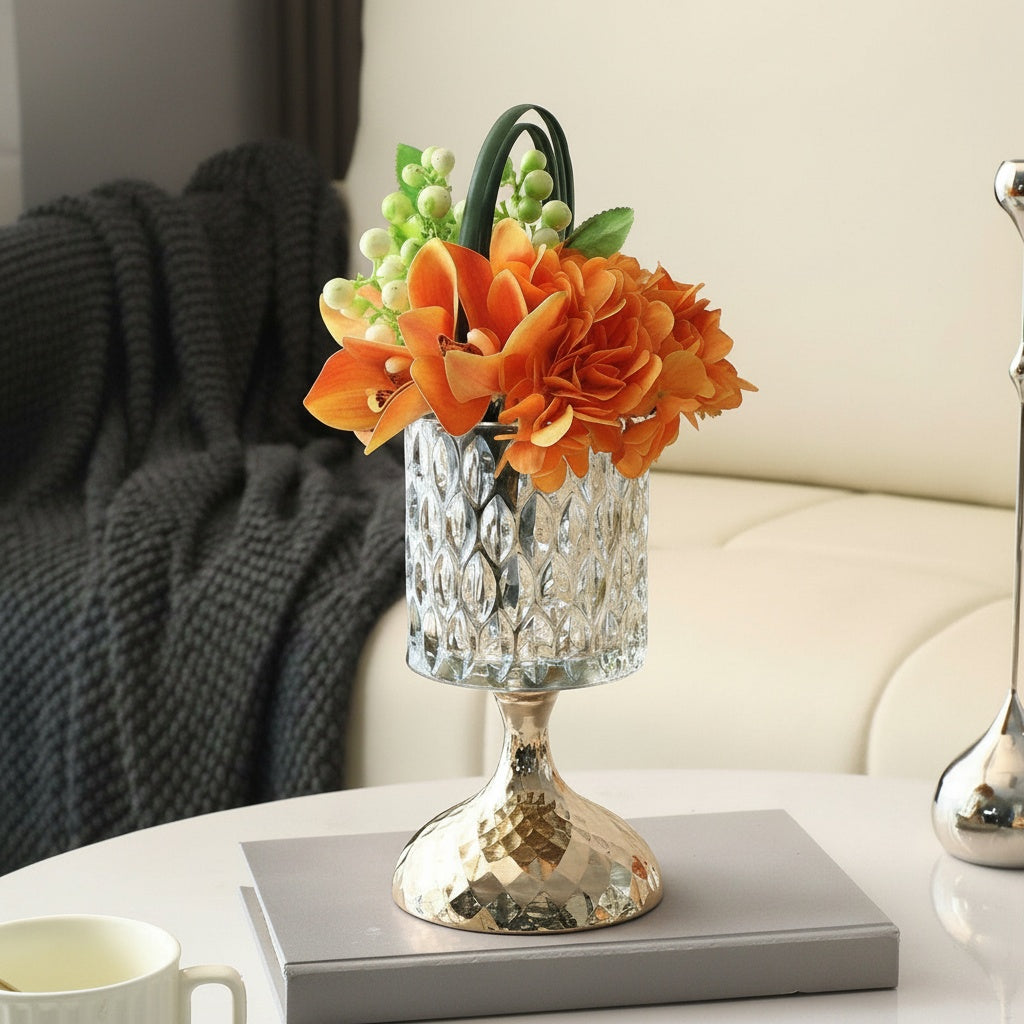 Textured glass and gold pedestal vase with orange floral arrangement