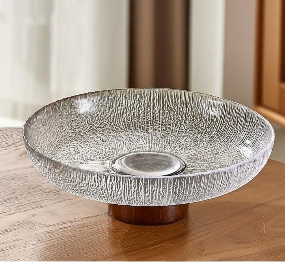 Clear textured glass bowl on wood base