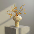 Top view of textured ceramic vase on books