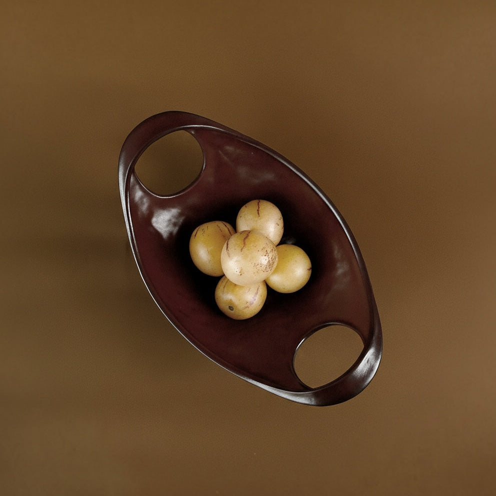 Top view of oval glazed bowl containing fruit