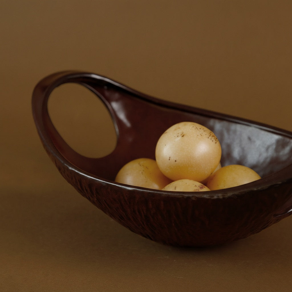 Close up of handle detail on textured ceramic bowl