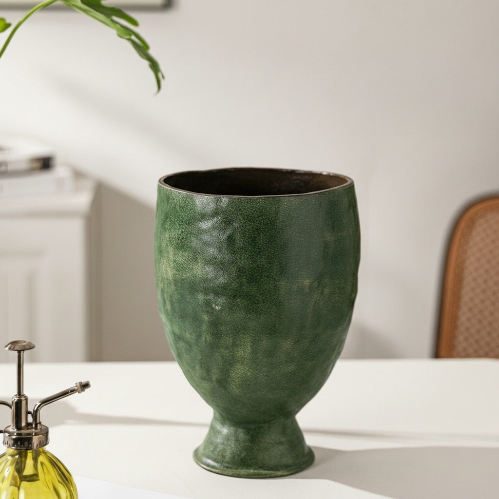 Empty textured green ceramic footed planter vessel close up