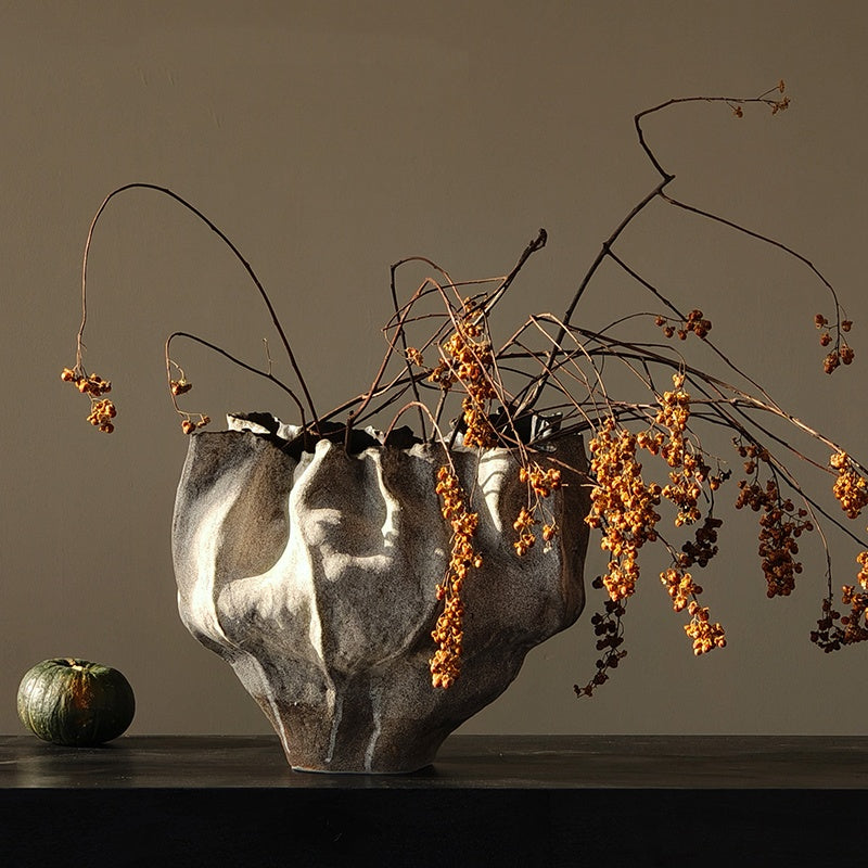 Sculptural grey vase with botanical arrangement