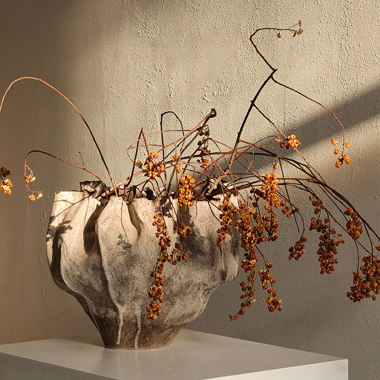 Artistic shadow play on grey ceramic vase