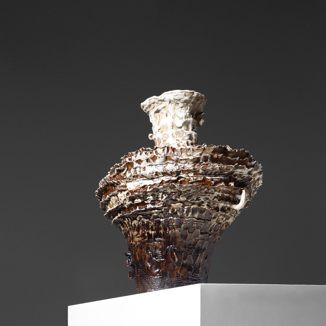 Detail view of glazed brown layered vase