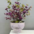 Textured lilac footed planter bowl styled with a decorative floral arrangement