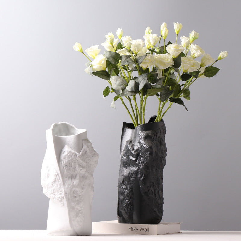 Textured ceramic vases in black and white with white flowers
