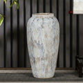 Close up of tall textured white ceramic vase with artisanal finish