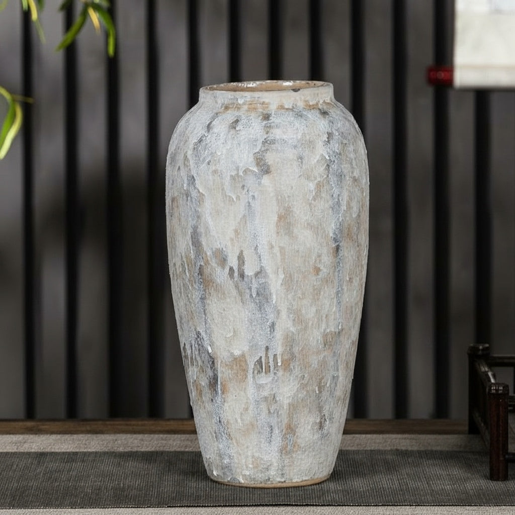 Close up of tall textured white ceramic vase with artisanal finish