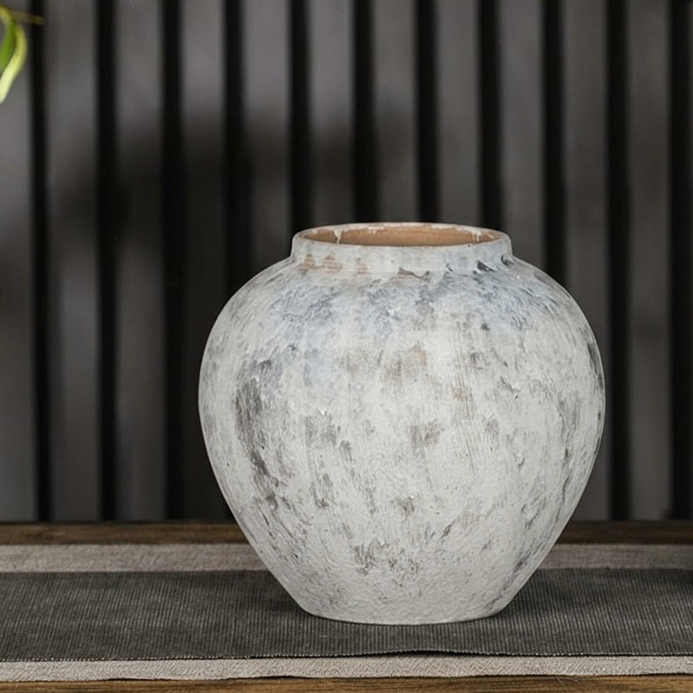 Round textured white ceramic vase with matte stone look finish