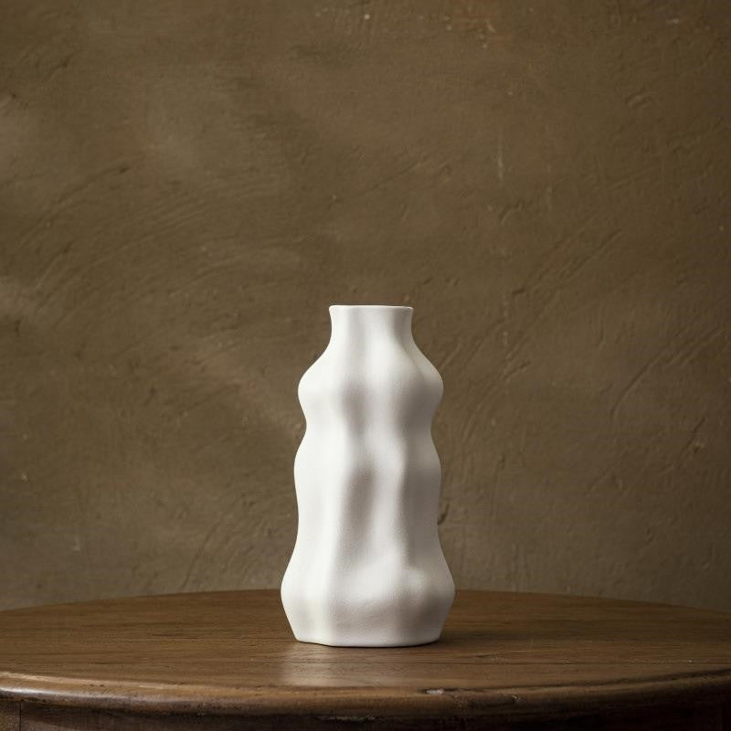 White textured ceramic vase with undulating shape