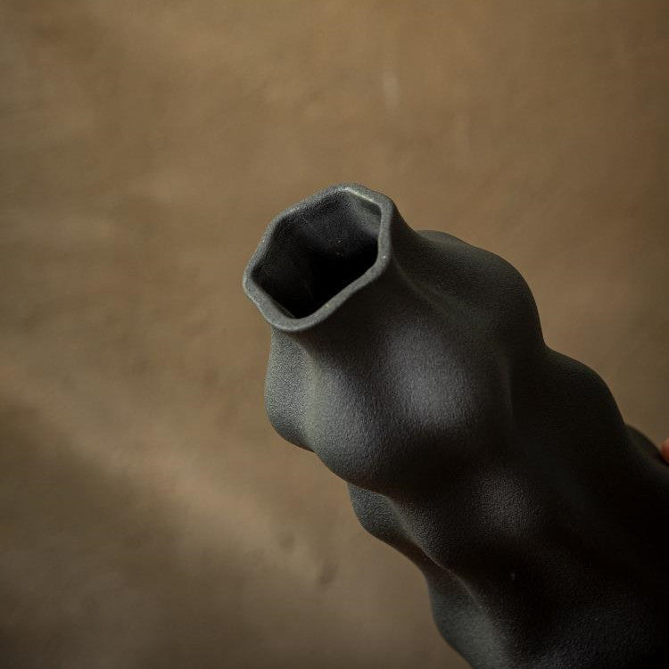 Top view of black ceramic vase showing hexagonal opening