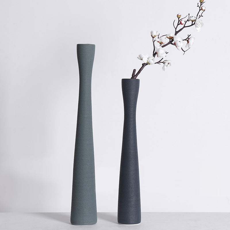 Textured matte charcoal ceramic vase with white blossoms