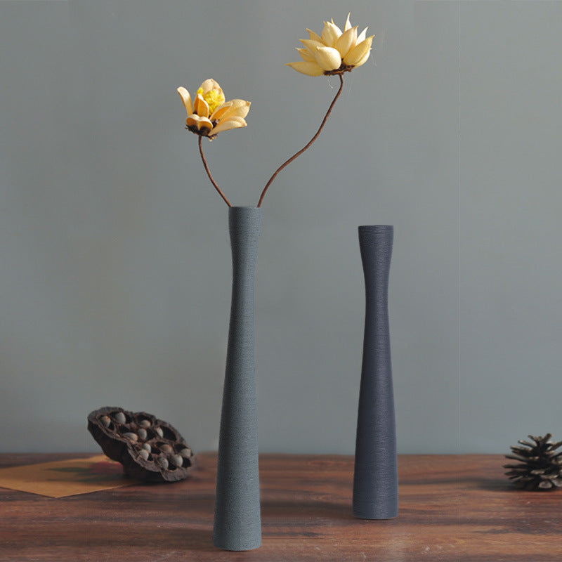 Minimalist grey ceramic vases on wooden table