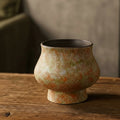 Textured ceramic pedestal vase with orange and moss green glaze
