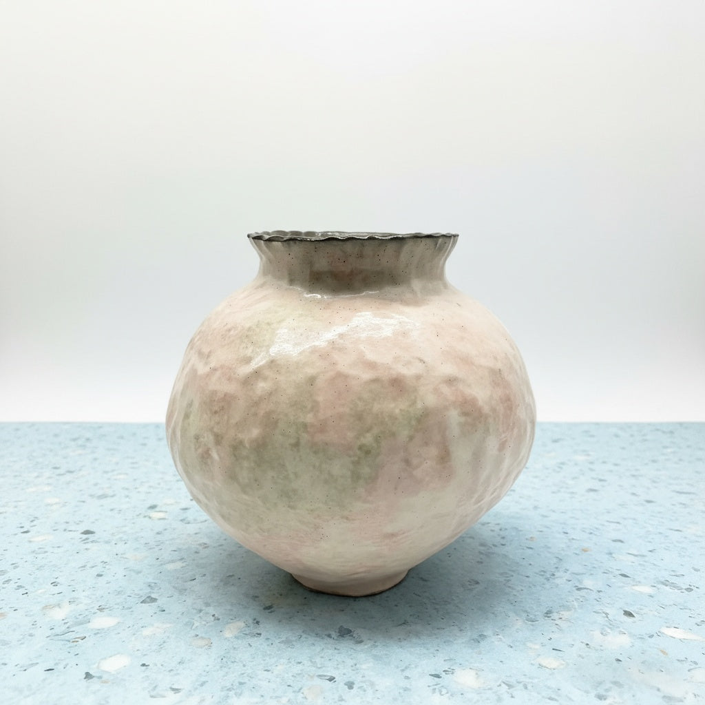 Front view of textured pastel ceramic vase with wavy rim