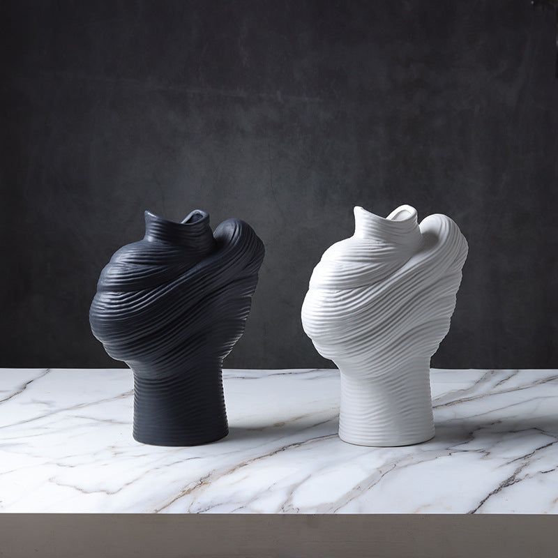 Angled view of abstract wrapped porcelain vases in black and white