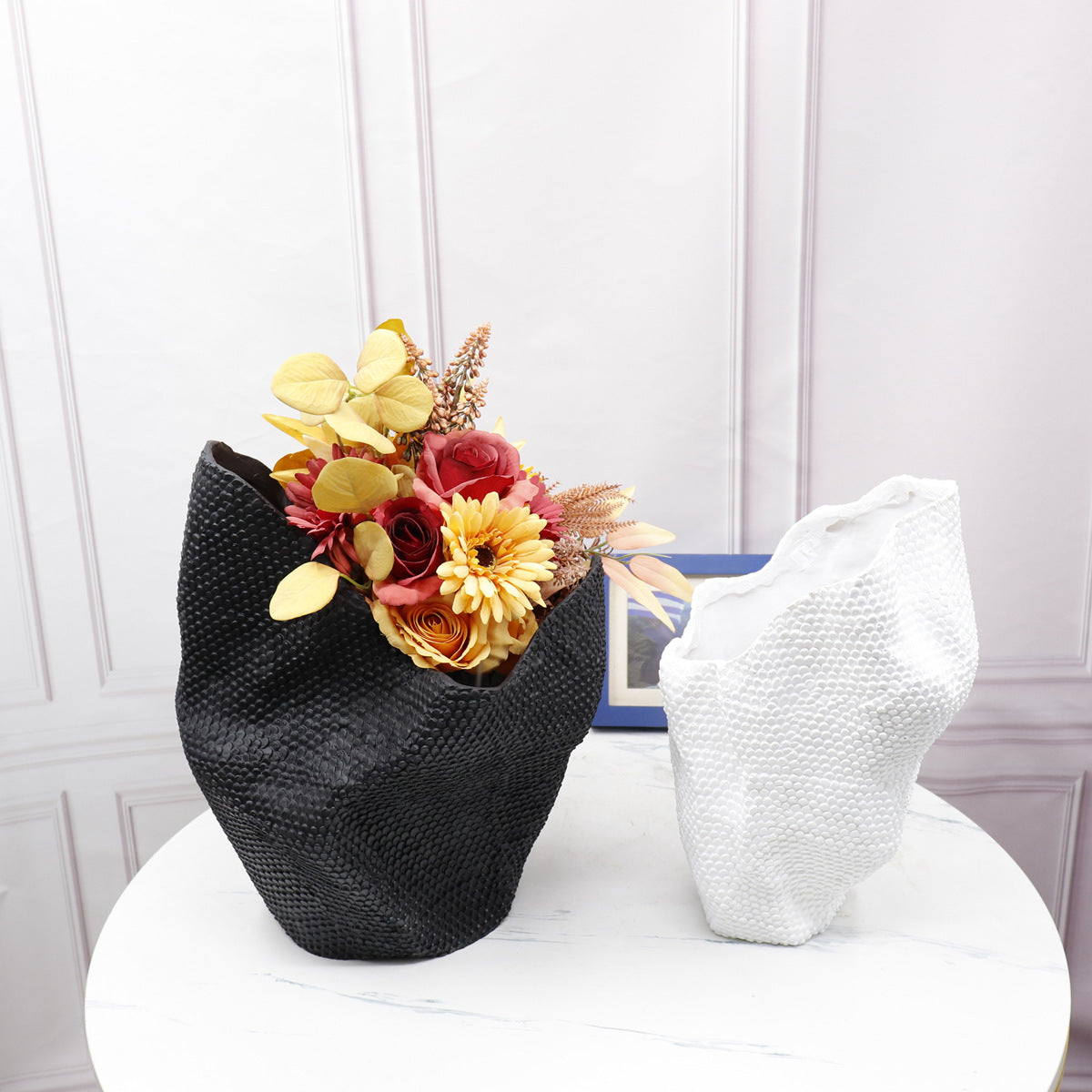 Black and white textured resin vases with floral arrangement