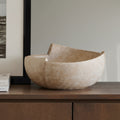 Textured resin sculptural bowl with organic rim on wooden console