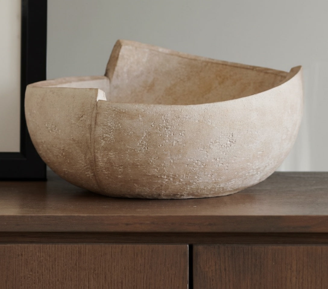 Side view of beige textured resin decorative bowl showing asymmetrical height